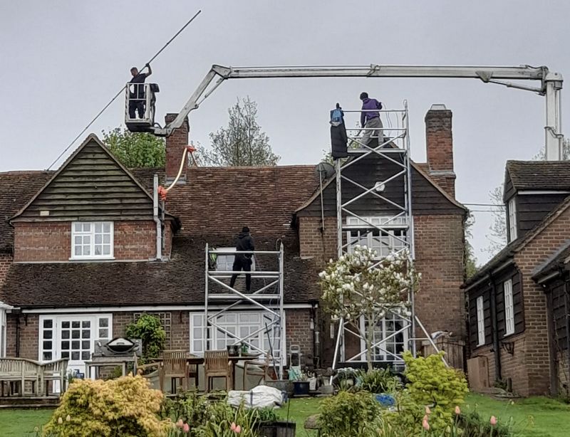 The Roof Moss Cleaners using cherry picker and scaffolding to clean roof safely and professionally in Andover, Hampshire